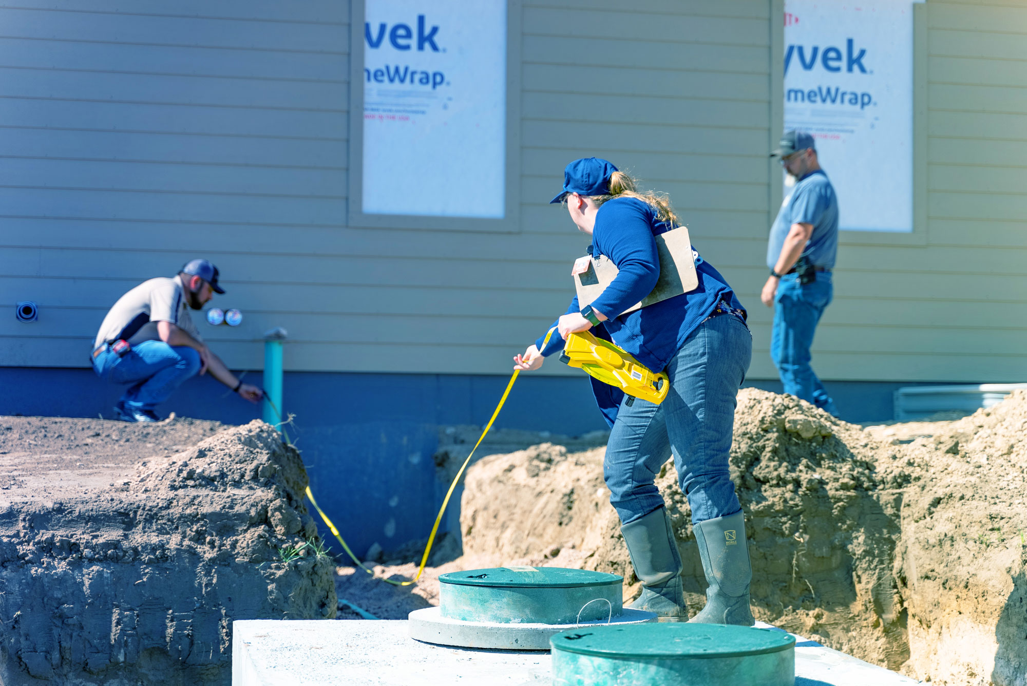 Group of people inspecting a septic tank