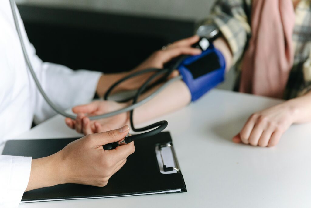 Photo shows a patient having blood pressure checked